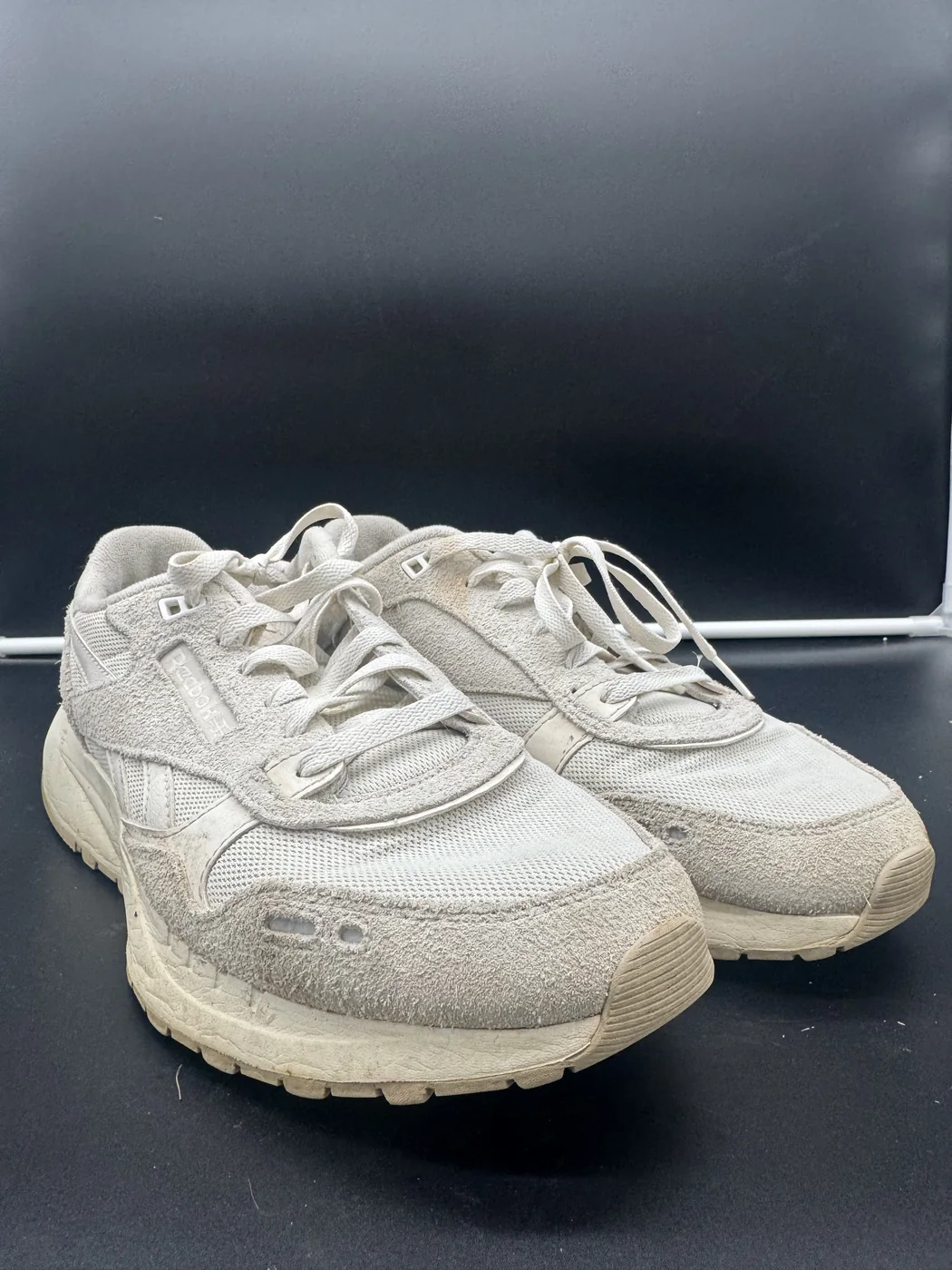 White retro runner before and after DRIP Sports sneaker cleaning - before